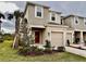 Two-story townhome with red front door and attached garage at 11739 Glenside Ter, Palmetto, FL 34221