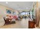 Living room with coral sofa and sliding glass doors leading to a patio at 13725 Messina Loop # 104, Bradenton, FL 34211