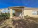 Back patio with access to grassy backyard at 15230 Searobbin Dr, Lakewood Ranch, FL 34202