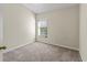 Simple bedroom with carpeted floors and window with blinds at 15230 Searobbin Dr, Lakewood Ranch, FL 34202