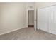 Secondary bedroom with carpeted floors and double door closet at 15230 Searobbin Dr, Lakewood Ranch, FL 34202