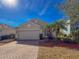 House exterior view with a paved driveway and palm trees at 15230 Searobbin Dr, Lakewood Ranch, FL 34202
