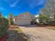 Tan house with a two-car garage and landscaped yard at 15230 Searobbin Dr, Lakewood Ranch, FL 34202