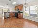 Eat-in kitchen featuring wood cabinets, stainless steel appliances, and laminate flooring at 15230 Searobbin Dr, Lakewood Ranch, FL 34202