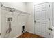 Laundry room with built-in shelving and wood floors at 15230 Searobbin Dr, Lakewood Ranch, FL 34202