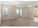 Bright living room with neutral carpeting and tiled floor at 15230 Searobbin Dr, Lakewood Ranch, FL 34202
