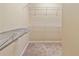 Large walk-in closet with wire shelving and carpeting at 15230 Searobbin Dr, Lakewood Ranch, FL 34202