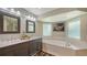 Bathroom with double vanity, soaking tub, and window at 1598 Oak N Cir, Sarasota, FL 34232