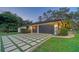 Two-car garage with a modern design and landscaping at 1598 Oak N Cir, Sarasota, FL 34232