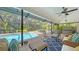 Relaxing poolside patio with wicker furniture and screened enclosure at 1598 Oak N Cir, Sarasota, FL 34232