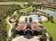 Community pool, clubhouse, and golf course view from above at 16528 Berwick Ter, Bradenton, FL 34202