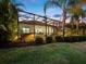 Evening view of backyard oasis with screened patio and landscape lighting at 16528 Berwick Ter, Bradenton, FL 34202