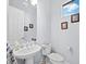 Clean bathroom with white sink and toilet, and a window at 16528 Berwick Ter, Bradenton, FL 34202