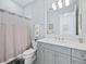 Bathroom with gray vanity, shower, and a toilet at 16528 Berwick Ter, Bradenton, FL 34202