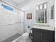 Modern bathroom with a walk-in shower and gray vanity at 16528 Berwick Ter, Bradenton, FL 34202