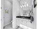 Modern bathroom with white vanity, dark countertop, and marble floor at 16528 Berwick Ter, Bradenton, FL 34202