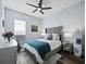 Spacious bedroom with gray upholstered headboard and teal blanket at 16528 Berwick Ter, Bradenton, FL 34202
