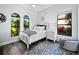 Cozy bedroom with white bed frame and a view of nature at 16528 Berwick Ter, Bradenton, FL 34202