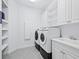 Laundry room with washer, dryer, and additional cabinets at 16528 Berwick Ter, Bradenton, FL 34202