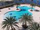 Resort-style pool with unique design and surrounding palm trees at 16528 Berwick Ter, Bradenton, FL 34202