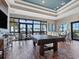 Game room with pool table, seating area, and large windows at 16528 Berwick Ter, Bradenton, FL 34202