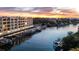 Modern building near the water with boats at sunset at 1703 N Tamiami Trl # 511, Sarasota, FL 34234