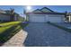 Two-car garage home with paver driveway and well-manicured lawn at 18028 Cherished Loop, Lakewood Ranch, FL 34211