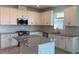 Modern kitchen with white cabinets, granite countertops, and island at 18028 Cherished Loop, Lakewood Ranch, FL 34211