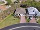 Aerial view of a single-Gathering home with a two-car garage and landscaped yard at 24748 Rio Villa Lakes Cir, Punta Gorda, FL 33950