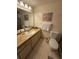 Bathroom featuring a toilet, sink, and vanity with ample storage at 2609 Woodgate Ln # K4, Sarasota, FL 34231