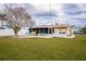 Backyard view with grassy lawn, screened porch, and shed at 2702 Avenue B, Holmes Beach, FL 34217