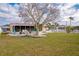 Backyard with large tree and grassy lawn at 2702 Avenue B, Holmes Beach, FL 34217