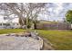 Backyard with large tree, gravel landscaping, and shed at 2702 Avenue B, Holmes Beach, FL 34217