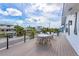 Relaxing deck overlooking the neighborhood with a table and chairs at 308 S Bay Blvd, Anna Maria, FL 34216