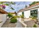 Landscaped side garden with gravel pathway, various plants, and a white stucco wall at 3321 Sheffield Cir, Sarasota, FL 34239