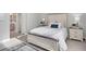Bright bedroom with white bed frame and blue rug at 364 Palmaria Ct, Nokomis, FL 34275