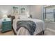 Guest bedroom with a comfy bed and teal nightstand at 364 Palmaria Ct, Nokomis, FL 34275