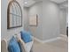 Bright entryway with a white bench, blue pillows, and tasteful wall art at 364 Palmaria Ct, Nokomis, FL 34275