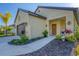 Tan house with brown garage door, walkway, landscaping, and a wreath on the front door at 364 Palmaria Ct, Nokomis, FL 34275