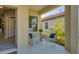 Relaxing front porch with two rocking chairs, a small table, and potted plants at 364 Palmaria Ct, Nokomis, FL 34275
