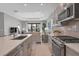 View of kitchen with stainless steel appliances and white quartz countertops at 364 Palmaria Ct, Nokomis, FL 34275