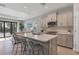 Modern kitchen with island, stainless steel appliances, and white quartz countertops at 364 Palmaria Ct, Nokomis, FL 34275