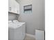 Bright laundry room with washer, dryer, and overhead cabinets at 364 Palmaria Ct, Nokomis, FL 34275