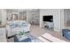 Open living space with light-colored sofas and a view into the kitchen and dining areas at 364 Palmaria Ct, Nokomis, FL 34275