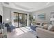 Living room with sliding glass doors leading to the patio and pool area at 364 Palmaria Ct, Nokomis, FL 34275