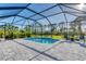 Relaxing screened pool and patio area with lounge chairs at 364 Palmaria Ct, Nokomis, FL 34275