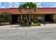Charming clubhouse entrance with palm trees, manicured landscaping and a terracotta roof at 4104 Catalina Dr, Bradenton, FL 34210
