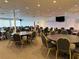 Spacious event room with round tables, chairs, dance floor, and stage area at 4104 Catalina Dr, Bradenton, FL 34210