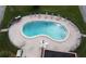 Kidney-shaped pool with surrounding patio and lounge chairs at 4104 Catalina Dr, Bradenton, FL 34210