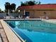 Inviting community pool with ample seating and patio umbrella at 4104 Catalina Dr, Bradenton, FL 34210